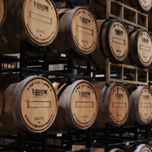 Stacked wooden barrels in distillery warehouse